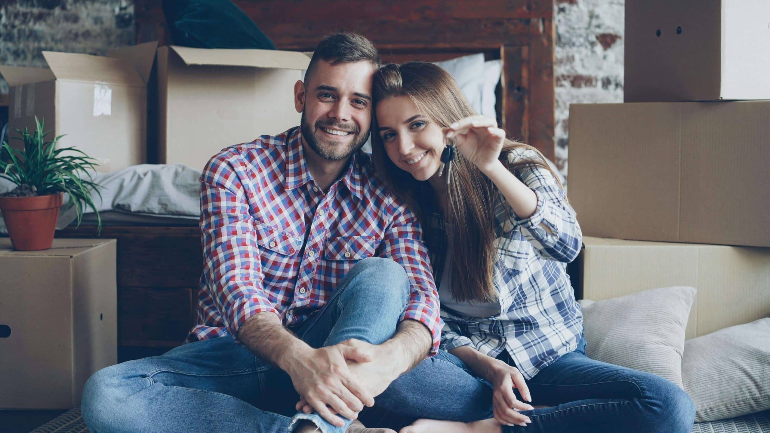 First-time homebuyer couple receiving keys with down payment assistance in Arizona