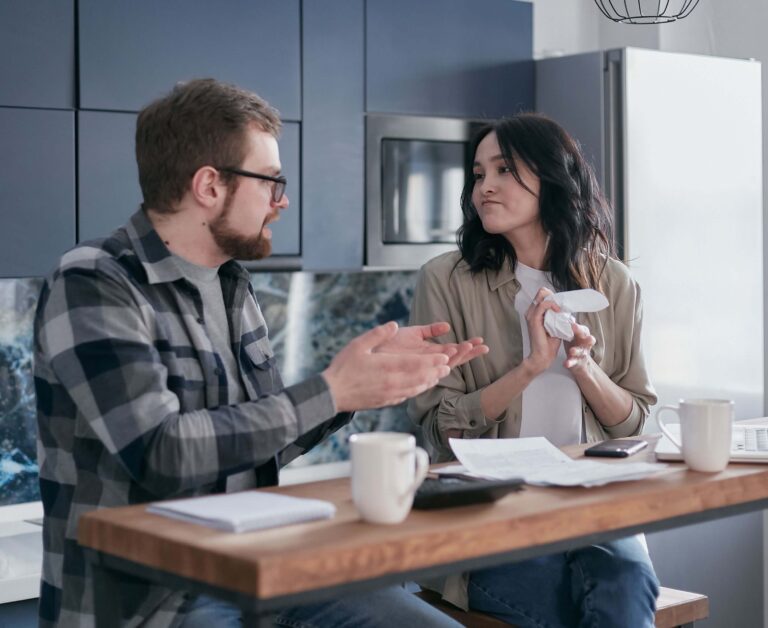 Arizona homeowner reviewing credit card statements considering a cash-out refinance for debt consolidation