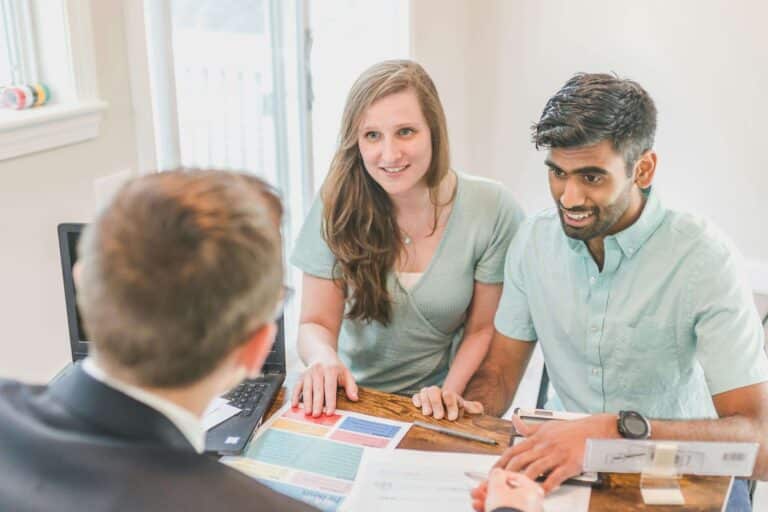 Arizona couple meeting with a mortgage lender to review documentation as part of the formal pre-approval process